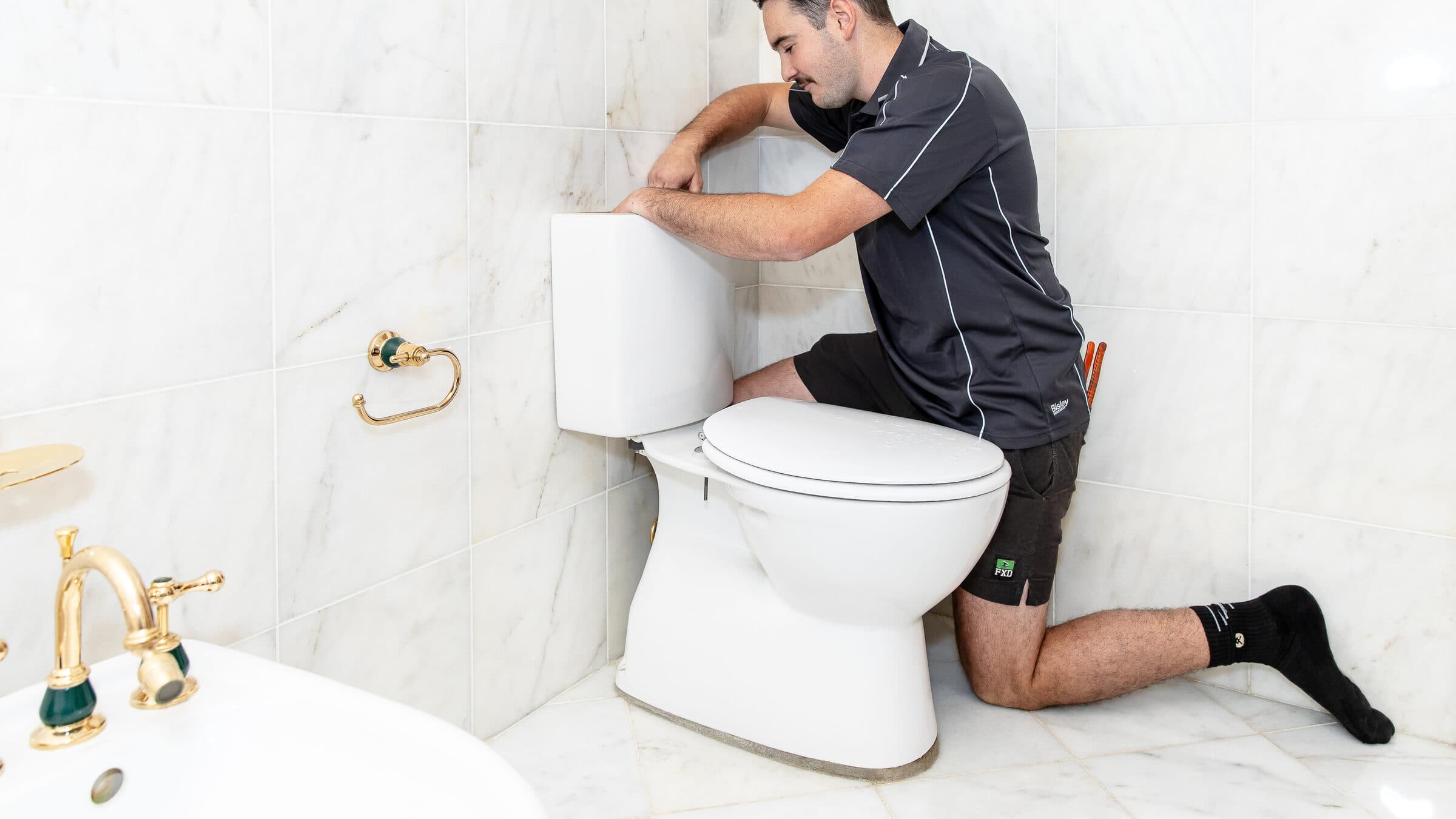 The open cistern of a toilet, showing the inlet valve and float that cause a toilet to keep running